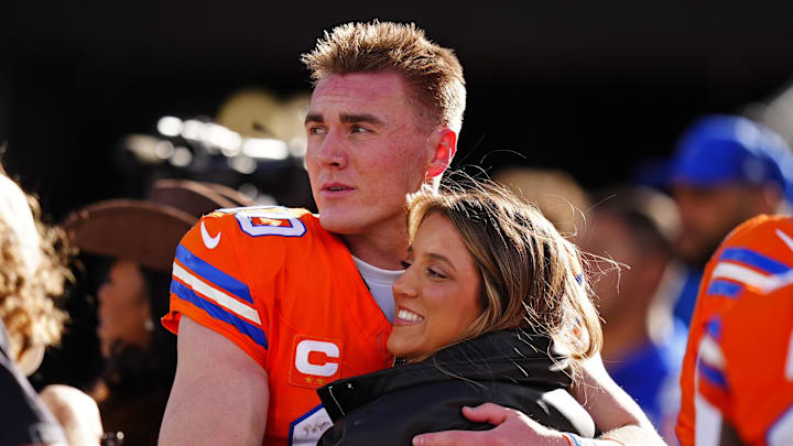 Jan 4, 2026; Denver, Colorado, USA; Denver Broncos quarterback Bo Nix (10) hugs wife, Izzy Nix before the game against the Los Angeles Chargers at Empower Field at Mile High. Mandatory Credit: Ron Chenoy-Imagn Images