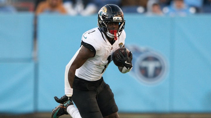 Jacksonville Jaguars running back Travis Etienne Jr. (1) runs with the ball against the Tennessee Titans during the second half at Nissan Stadium.