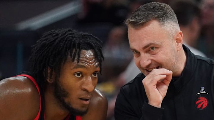 Immanuel Quickley listens to Toronto Raptors head coach Darko Rajakovic.