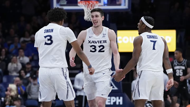 Dailyn Swain #3, Zach Freemantle #32, and Ryan Conwell #7 of the Xavier Musketeers celebrate in the second half at the Cintas Center on February 04, 2025 in Cincinnati, Ohio. 
