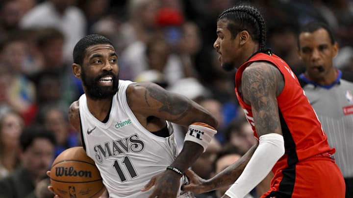 Feb 8, 2025; Dallas, Texas, USA; Dallas Mavericks guard Kyrie Irving (11) looks to pass the ball past Houston Rockets guard Jalen Green (4) during the second quarter at American Airlines Center. Mandatory Credit: Jerome Miron-Imagn Images