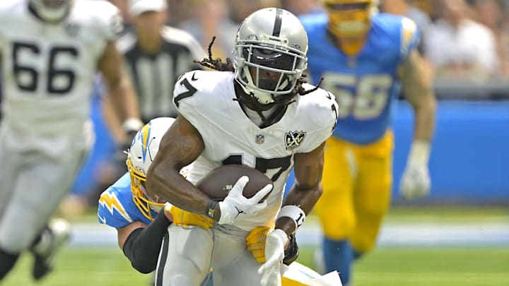Sep 8, 2024; Inglewood, California, USA; Las Vegas Raiders wide receiver Davante Adams (17) is stopped by Los Angeles Chargers safety Alohi Gilman (32) after a compete pass in the first half at SoFi Stadium. Mandatory Credit: Jayne Kamin-Oncea-Imagn Images