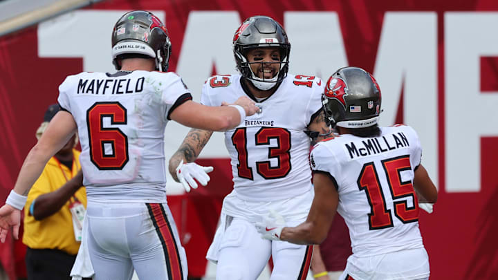 Sep 8, 2024; Tampa, Florida, USA;  Tampa Bay Buccaneers wide receiver Mike Evans (13)  is congratulated by quarterback Baker Mayfield (6) and wide receiver Jalen McMillan (15) after he scored a touchdown against the Washington Commanders during the first half at Raymond James Stadium. Mandatory Credit: Kim Klement Neitzel-Imagn Images