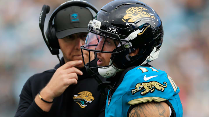 Jacksonville Jaguars wide receiver Parker Washington (11) walks off the field after a hit as head coach Liam Coen looks on during the second quarter of an NFL football matchup at EverBank Stadium, Sunday, Jan. 4, 2026, in Jacksonville, Fla. The Jaguars defeated the Titans 41-7, capturing the AFC South title. 