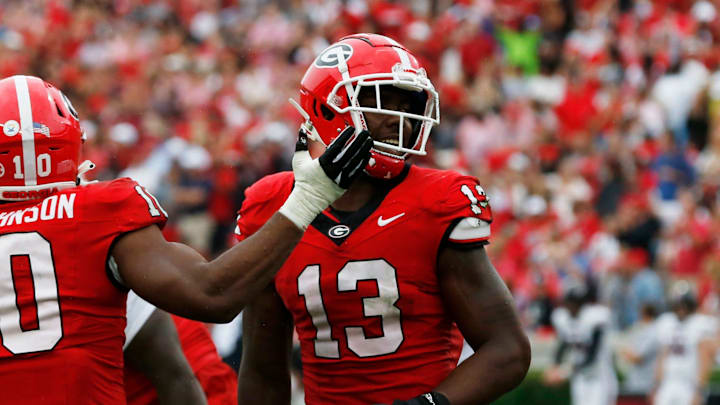 Georgia defensive lineman Mykel Williams (13) celebrates with Georgia linebacker Jamon Dumas-Johnson (10) after sacking South Carolina quarterback Spencer Rattler (7) during the second half of a NCAA college football game against South Carolina in Athens, Ga., on Saturday, Sept. 16, 2023. Georgia won 24-14.