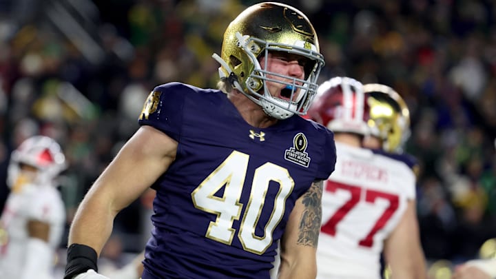 Dec 20, 2024; Notre Dame, Indiana, USA; Notre Dame Fighting Irish defensive lineman Joshua Burnham (40) reacts after a play during the first quarter against the Indiana Hoosiers at Notre Dame Stadium.
