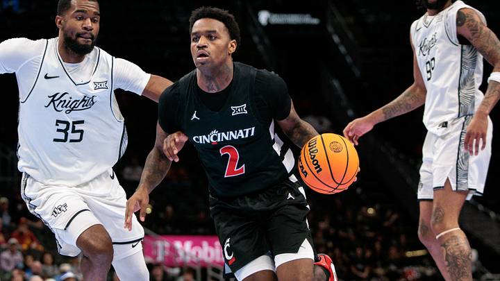 Mar 11, 2026; Kansas City, MO, USA; Cincinnati Bearcats guard Jizzle James (2) brings the ball up court around UCF Knights forward Devan Cambridge (35) during the second half at T-Mobile Center. Mandatory Credit: William Purnell-Imagn Images Mar 11, 2026; Kansas City, MO, USA; Cincinnati Bearcats guard Jizzle James (2) brings the ball up court around UCF Knights forward Devan Cambridge (35) during the second half at T-Mobile Center. Mandatory Credit: William Purnell-Imagn Images