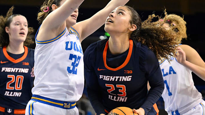 Feb 20, 2025; Los Angeles, California, USA; Illinois Fighting Illini forward Brynn Shoup-Hill (23) tries to score defend by UCLA Bruins forward Angela Dugalic (32) during the second quarter at Pauley Pavilion presented by Wescom. Mandatory Credit: Robert Hanashiro-Imagn Images