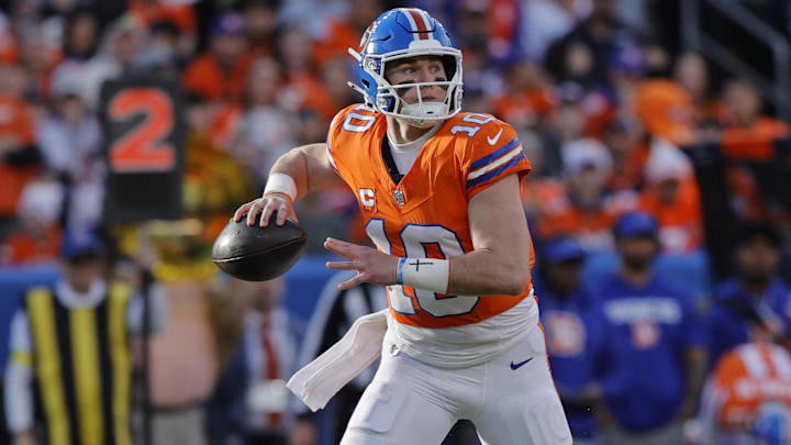 Jan 4, 2026; Denver, Colorado, USA; Denver Broncos quarterback Bo Nix (10) looks to pass the ball during the game against the Los Angeles Chargers during the first half at Empower Field at Mile High. 