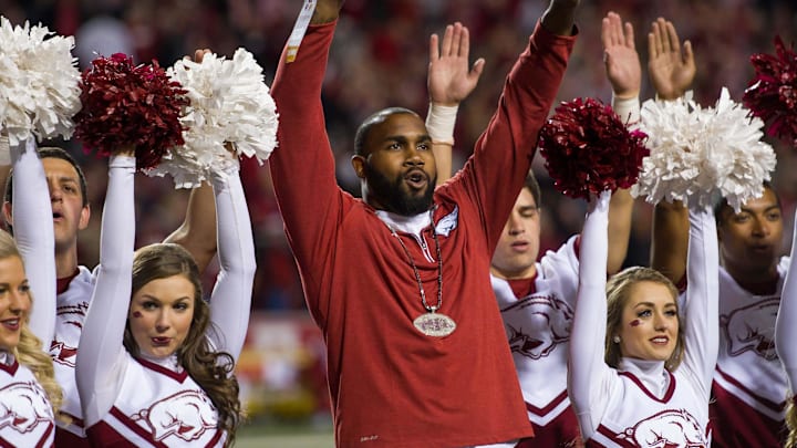 Nov 12, 2016; Fayetteville, AR, USA;  Arkansas Razorbacks former running back Darren McFadden (center) is honored between quarters and helps the spirit squad lead the crowd in a cheer during the game against the LSU Tigers at Donald W. Reynolds Razorback Stadium. LSU won 38-10. Mandatory Credit: Brett Rojo-Imagn Images