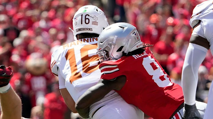Ohio State Buckeyes linebacker Arvell Reese tackles Texas Longhorns quarterback Arch Manning