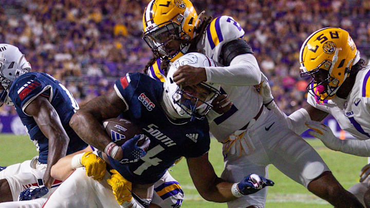 South Alabama Jaguars running back Fluff Bothwell (24) is tackled by LSU Tigers linebacker Whit Weeks (40) during the second half at Tiger Stadium.