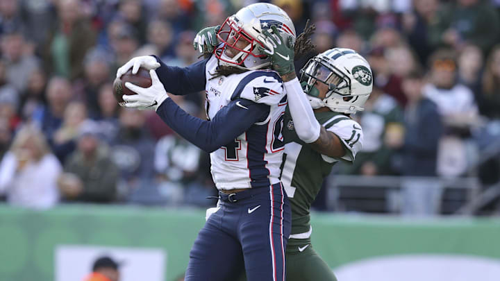 Nov 25, 2018; East Rutherford, NJ, USA; New England Patriots cornerback Stephon Gilmore (24) intercepts a pass intended for New York Jets wide receiver Robby Anderson (11) during the second quarter at MetLife Stadium. Mandatory Credit: Brad Penner-Imagn Images