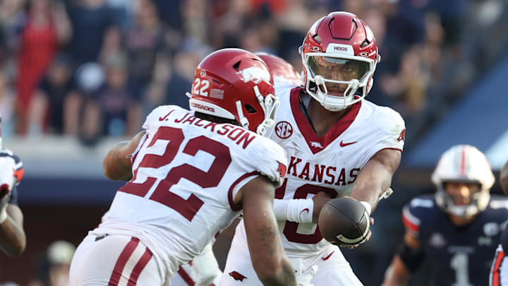 Arkansas Razorbacks quarterback Taylen Green (10) hands off to running back Ja'Quinden Jackson (22) during the fourth quarter against the Auburn Tigers at Jordan-Hare Stadium.
