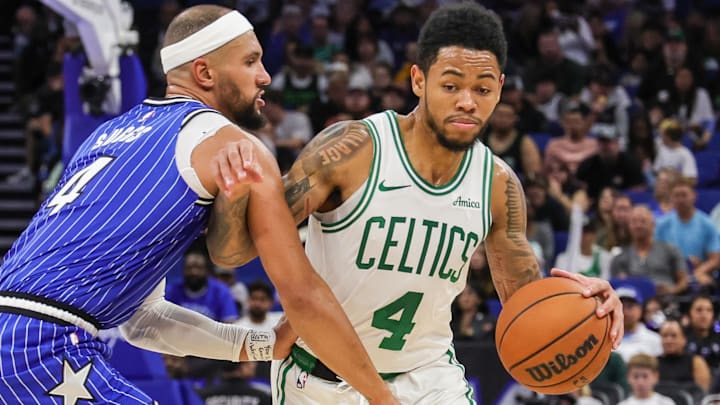 Nov 9, 2025; Orlando, Florida, USA; Boston Celtics guard Anfernee Simons (4) drives past Orlando Magic guard Jalen Suggs (4) during the second quarter at Kia Center.