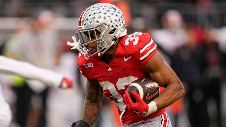 Ohio State Buckeyes running back TreVeyon Henderson (32) runs upfield during the NCAA football game against the Indiana Hoosiers at Ohio Stadium in Columbus on Monday, Nov. 25, 2024. Ohio State won 38-15. Ohio State Buckeyes running back TreVeyon Henderson (32) runs upfield during the NCAA football game against the Indiana Hoosiers at Ohio Stadium in Columbus on Monday, Nov. 25, 2024. Ohio State won 38-15.