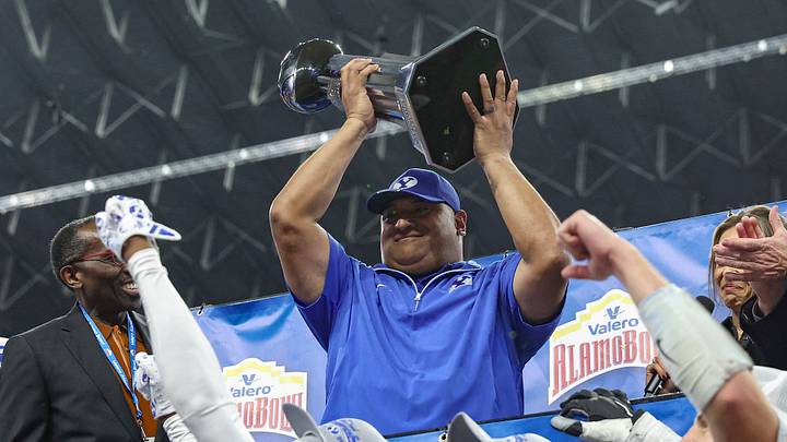 Dec 28, 2024; San Antonio, TX, USA; Brigham Young Cougars head coach Kalani Sitake holds the Alamo Bowl championship trophy after the game against the Colorado Buffaloes at Alamodome. Mandatory Credit: Troy Taormina-Imagn Images