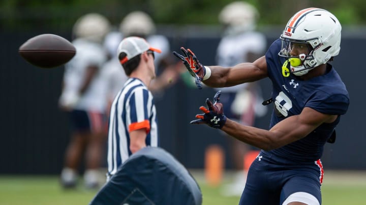 Auburn Tigers wide receiver Cam Coleman (8) catches a pass during practice at Woltosz Football