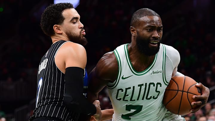 Nov 23, 2025; Boston, Massachusetts, USA; Orlando Magic guard Tyus Jones (2) defends Boston Celtics guard Jaylen Brown (7) during the second half at TD Garden. Mandatory Credit: Bob DeChiara-Imagn Images