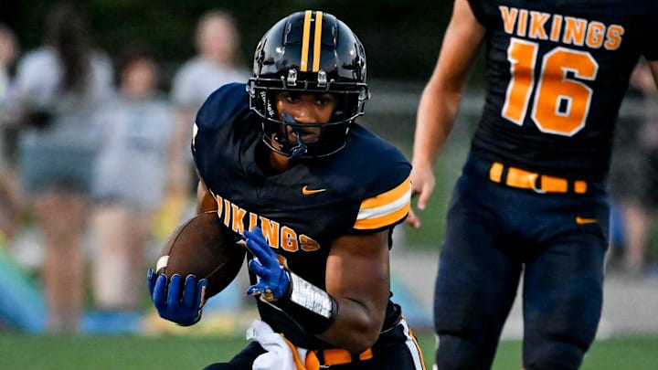 Haslett's Kory Amachree runs for a gain against DeWitt during the second quarter on Thursday, Aug. 29, 2024, at Haslett High School.