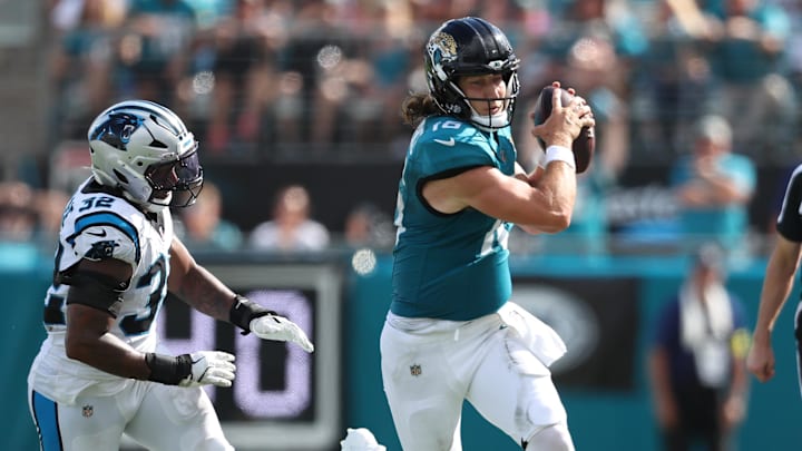 Sep 7, 2025; Jacksonville, Florida, USA; Jacksonville Jaguars quarterback Trevor Lawrence (16) carries the ball as Carolina Panthers linebacker Trevin Wallace (32) defends during the second half at EverBank Stadium. Mandatory Credit: Morgan Tencza-Imagn Images Sep 7, 2025; Jacksonville, Florida, USA; Jacksonville Jaguars quarterback Trevor Lawrence (16) carries the ball as Carolina Panthers linebacker Trevin Wallace (32) defends during the second half at EverBank Stadium. Mandatory Credit: Morgan Tencza-Imagn Images