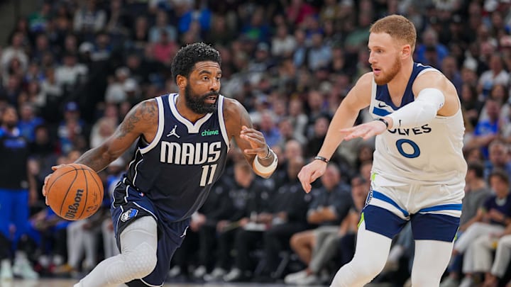 Oct 29, 2024; Minneapolis, Minnesota, USA; Dallas Mavericks guard Kyrie Irving (11) dribbles against the Minnesota Timberwolves guard Donte DiVincenzo (0) in the fourth quarter at Target Center. Mandatory Credit: Brad Rempel-Imagn Images
