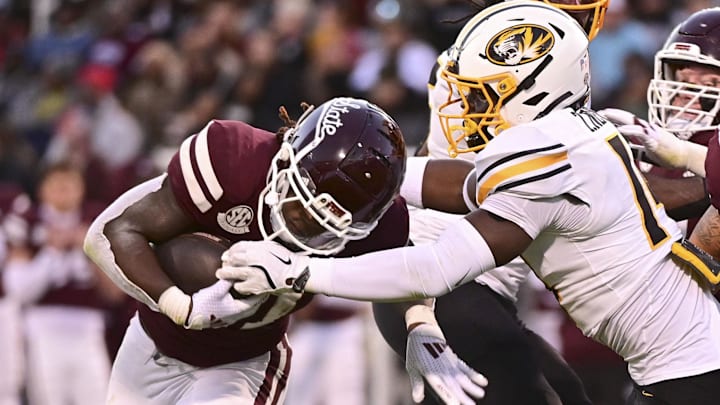 Mississippi State Bulldogs running back Davon Booth (21) runs against  Missouri Tigers linebacker Triston Newson (14) during the second quarter at Davis Wade Stadium at Scott Field.