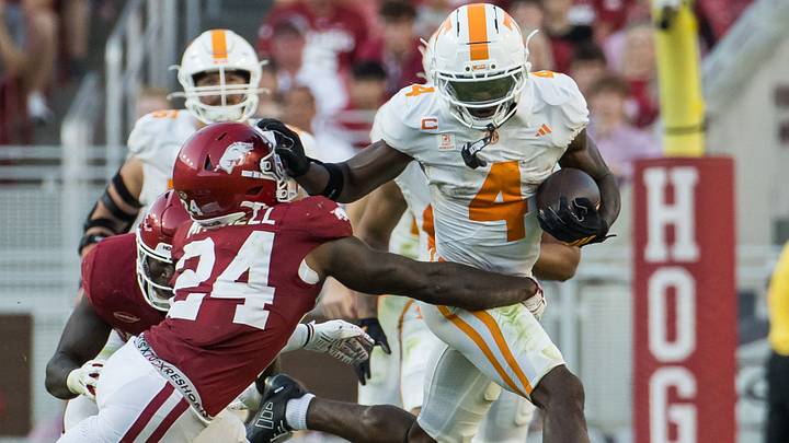 Tennessee Volunteers wide receiver Mike Matthews (4) stiff arms Arkansas Razorbacks defensive back Miguel Mitchell (24) during the fourth quarter at Razorback Stadium. Tennessee Volunteers wide receiver Mike Matthews (4) stiff arms Arkansas Razorbacks defensive back Miguel Mitchell (24) during the fourth quarter at Razorback Stadium.