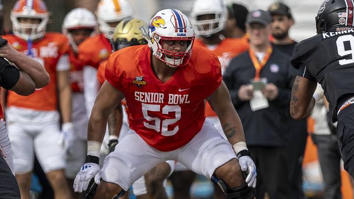 Jan 28, 2025; Mobile, AL, USA; American team offensive lineman Logan Brown of Kansas (52) sets up to block during Senior Bowl practice for the American team at Hancock Whitney Stadium.