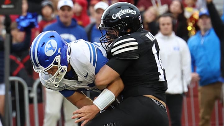 Oct 25, 2025; Ames, Iowa, USA; BYU Cougars quarterback Bear Bachmeier (47) is tackled by Iowa State Cyclones linebacker Carson Willich (14) at Jack Trice Stadium.