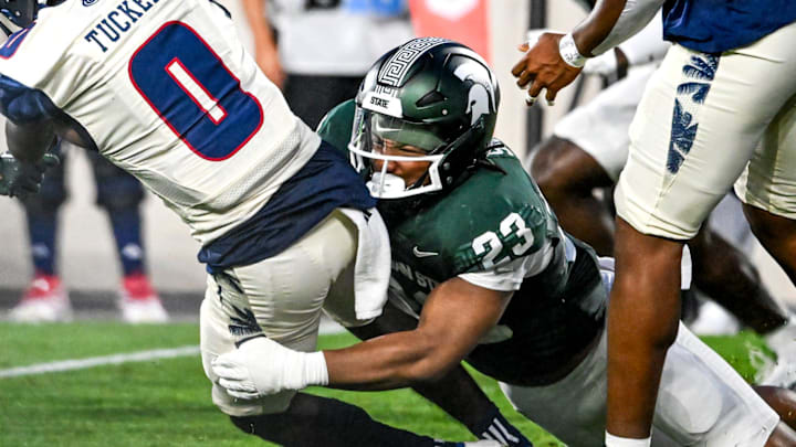 Michigan State's Darius Snow, right, tackles Florida Atlantic's Milan Tucker during the second quarter on Friday, Aug. 30, 2024, at Spartan Stadium in East Lansing.