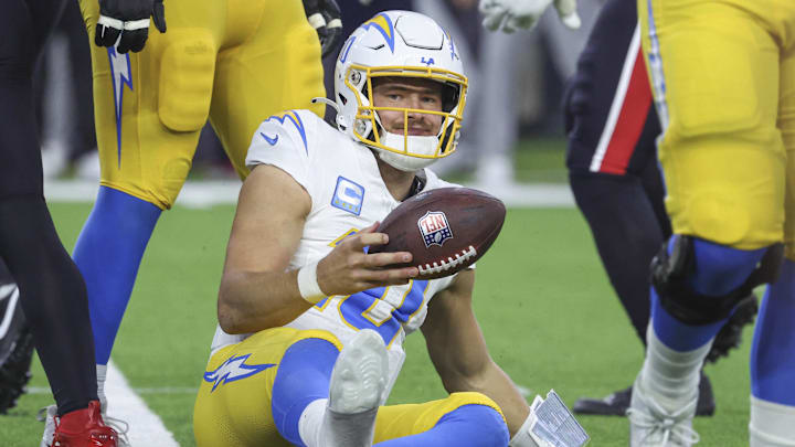 Jan 11, 2025; Houston, Texas, USA; Los Angeles Chargers quarterback Justin Herbert (10) reacts after being sacked during the game against the Houston Texans in an AFC wild card game at NRG Stadium. Mandatory Credit: Troy Taormina-Imagn Images