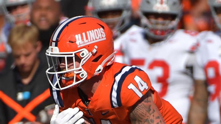 Oct 11, 2025; Champaign, Illinois, USA; Ohio State Buckeyes defensive back Caleb Downs (2) pulls on the jersey of Illinois Fighting Illini tight end Cole Rusk (14) during the second half at Memorial Stadium. Mandatory Credit: Ron Johnson-Imagn Images