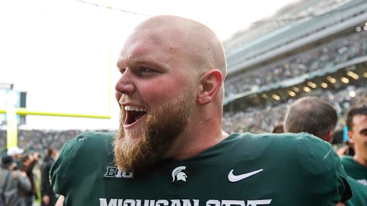 Michigan State offensive lineman Matt Allen (64)  celebrates the 37-33 win over Michigan at Spartan Stadium in East Lansing on Saturday, Oct. 30, 2021.