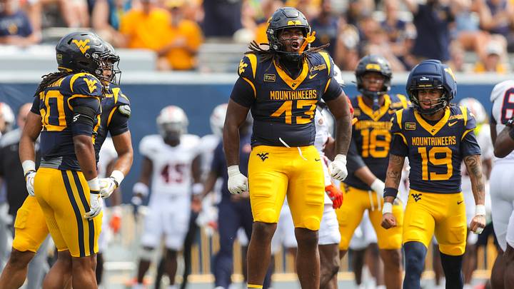 Sep 12, 2026; Morgantown, West Virginia, USA; West Virginia Mountaineers defensive lineman K.J. Henson (43) celebrates after a defensive stop during the first quarter against the UT Martin Skyhawks at Milan Puskar Stadium. Mandatory Credit: Ben Queen-Imagn Images Sep 12, 2026; Morgantown, West Virginia, USA; West Virginia Mountaineers defensive lineman K.J. Henson (43) celebrates after a defensive stop during the first quarter against the UT Martin Skyhawks at Milan Puskar Stadium. Mandatory Credit: Ben Queen-Imagn Images