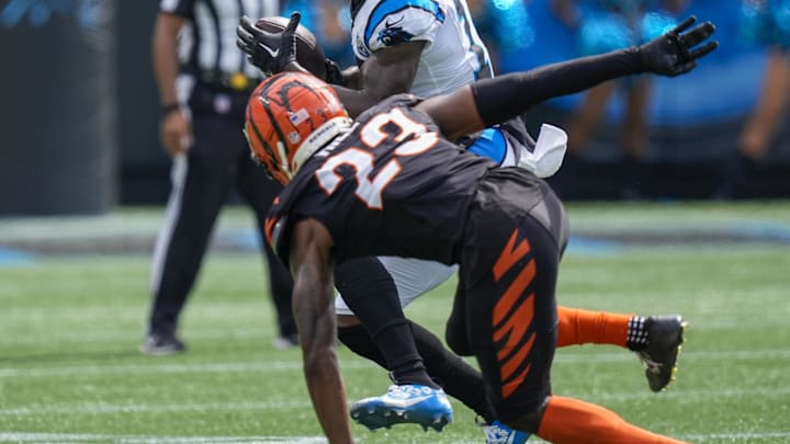 Carolina Panthers wide receiver Jonathan Mingo (15) looks to elude Cincinnati Bengals cornerback Dax Hill (23). Mandatory Credit: Jim Dedmon-Imagn Images