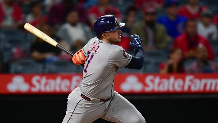Sep 26, 2025; Anaheim, California, USA; Houston Astros catcher Yainer Diaz (21) hits a double against the Los Angeles Angels during the second inning at Angel Stadium. Mandatory Credit: Gary A. Vasquez-Imagn Images