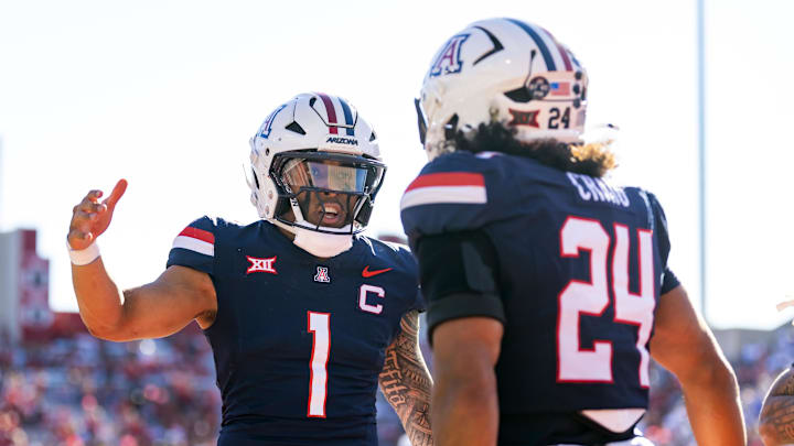 Nov 8, 2025; Tucson, Arizona, USA; Arizona Wildcats quarterback Noah Fifita (1) celebrates a touchdown with running back Quincy Craig (24) against the Kansas Jayhawks at Arizona Stadium. Mandatory Credit: Mark J. Rebilas-Imagn Images