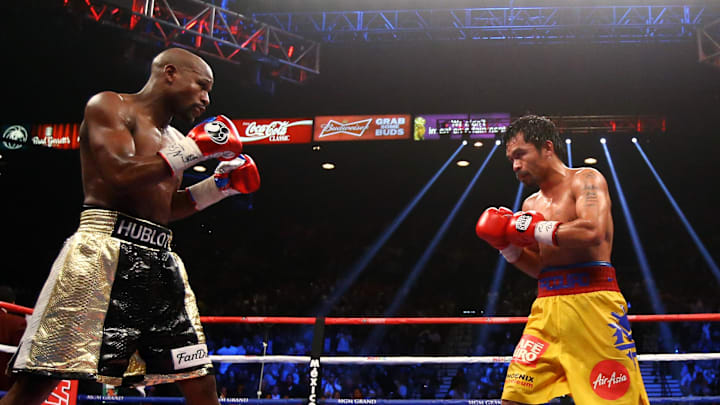 May 2, 2015; Las Vegas, NV, USA; Manny Pacquiao (right) against Floyd Mayweather during their boxing bout at the MGM Grand Garden Arena. Mandatory Credit: Mark J. Rebilas-Imagn Images