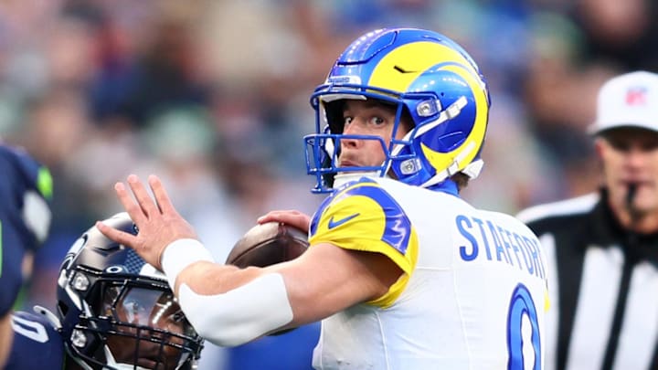 Jan 25, 2026; Seattle, WA, USA; Los Angeles Rams quarterback Matthew Stafford (9) passes against Seattle Seahawks defensive end DeMarcus Lawrence (0) during the first half in the 2026 NFC Championship Game at Lumen Field. Mandatory Credit: Kevin Ng-Imagn Images