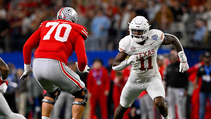 Jan 10, 2025; Arlington, TX, USA; Ohio State Buckeyes offensive lineman Josh Fryar (70) and Texas Longhorns linebacker Colin Simmons (11) in action during the game between the Texas Longhorns and the Ohio State Buckeyes at AT&T Stadium. Mandatory Credit: Jerome Miron-Imagn Images