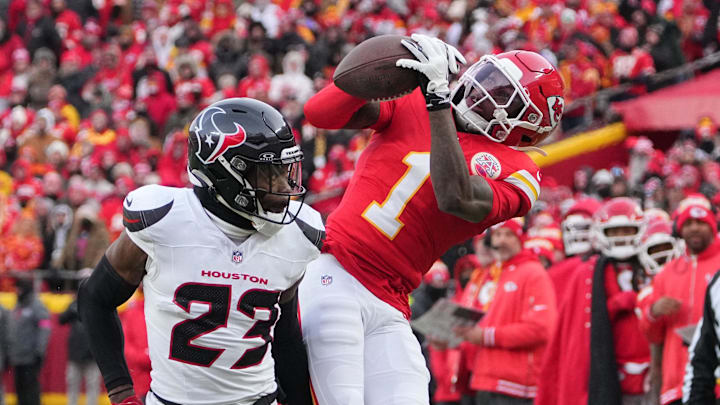 Jan 18, 2025; Kansas City, Missouri, USA; Kansas City Chiefs wide receiver Xavier Worthy (1) makes a catch against Houston Texans safety Eric Murray (23) during the first quarter of a 2025 AFC divisional round game at GEHA Field at Arrowhead Stadium. Mandatory Credit: Denny Medley-Imagn Images