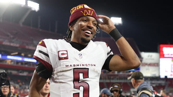 Jan 12, 2025; Tampa, Florida, USA; Washington Commanders quarterback Jayden Daniels (5) celebrates after winning a NFC wild card playoff against the Tampa Bay Buccaneers at Raymond James Stadium. Mandatory Credit: Nathan Ray Seebeck-Imagn Images