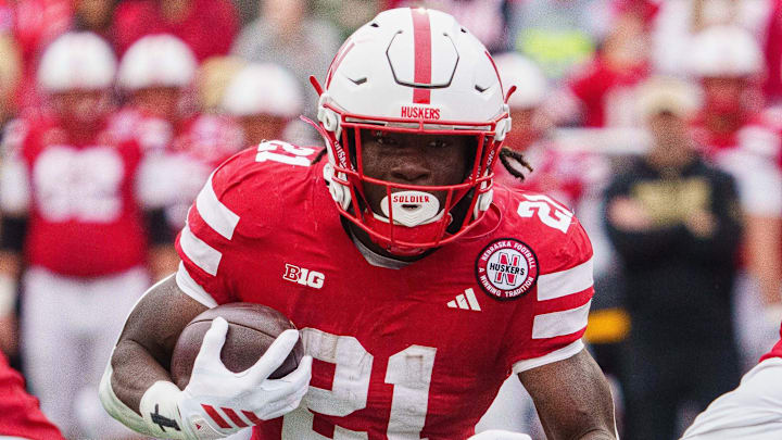 Oct 25, 2025; Lincoln, Nebraska, USA; Nebraska Cornhuskers running back Emmett Johnson (21) runs the ball against the Northwestern Wildcats during the first quarter at Memorial Stadium. Mandatory Credit: Dylan Widger-Imagn Images