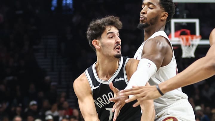 Oct 24, 2025; Brooklyn, New York, USA;  Brooklyn Nets guard Ben Saraf (77) is double teammed by Cleveland Cavaliers guard Donovan Mitchell (45) and center Jarrett Allen (31) in the first quarter at Barclays Center. Mandatory Credit: Wendell Cruz-Imagn Images