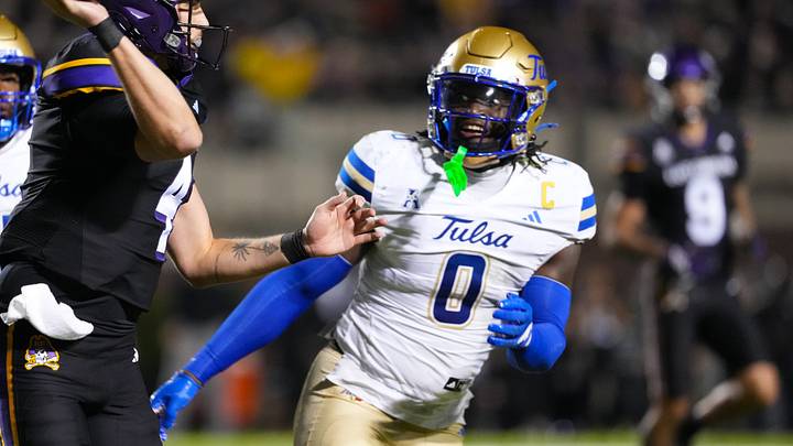 East Carolina Pirates quarterback Katin Houser (4) throws the ball against Tulsa Golden Hurricane linebacker Ray Coney (0) during the first half at Dowdy-Ficklen Stadium. East Carolina Pirates quarterback Katin Houser (4) throws the ball against Tulsa Golden Hurricane linebacker Ray Coney (0) during the first half at Dowdy-Ficklen Stadium.