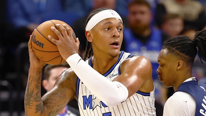 Mar 3, 2026; Orlando, Florida, USA;  Washington Wizards guard Bub Carrington (7) attempts to defend Orlando Magic forward Paolo Banchero (5)in the first half at Kia Center. Mandatory Credit: Russell Lansford-Imagn Images