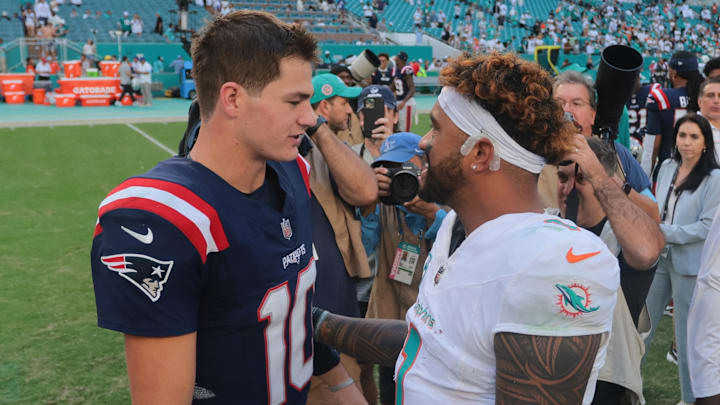 Nov 24, 2024; Miami Gardens, Florida, USA; New England Patriots quarterback Drake Maye (10) and Miami Dolphins quarterback Tua Tagovailoa (1) talk on the field after the game at Hard Rock Stadium. Mandatory Credit: Sam Navarro-Imagn Images