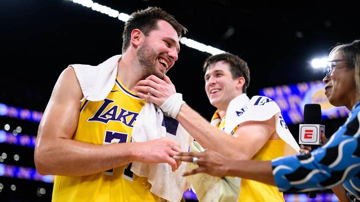 Mar 14, 2026; Los Angeles, California, USA; Los Angeles Lakers guard Luka Doncic (77) reacts with guard Austin Reaves (15) after scoring a game winning shot during overtime against the Denver Nuggets at Crypto.com Arena. Mandatory Credit: William Liang-Imagn Images