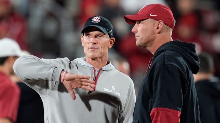 Oklahoma coach Brent Venables talks with Alabama coach Kalen DeBoer.